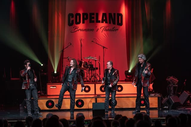 A band in sequined jackets performing on stage